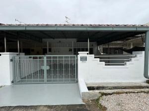 a gate in front of a building with stairs at Yipstay Gopeng HomeTown in Gopeng