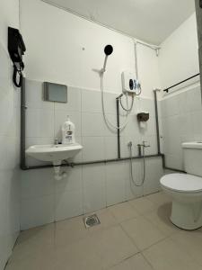 a bathroom with a shower and a toilet and a sink at Yipstay Gopeng HomeTown in Gopeng +5 photos