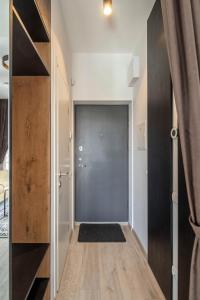a hallway with a sliding door in a house at Cozy Palanga Apartment in Palanga