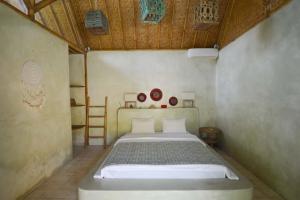 Voodi või voodid majutusasutuse Tipsea Turtle Gili Air toas