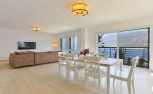 a living room with a table and chairs and a couch at Stella Sea View & Access to Sea in Kas