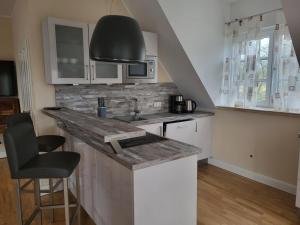 a kitchen with a sink and a counter top at Ferienwohnung Gala in Stade +2 photos