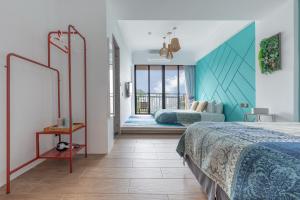 a hotel room with a bed and a balcony at Kenting Fu Bao Inn in Hengchun South Gate +59 photos