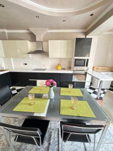 a kitchen with a dining table with two chairs at Altyn Horde in Almaty
