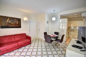 a living room with a red couch and a table at Valletta Central Apartment in Valletta