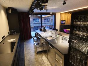 a kitchen with a sink and a counter with a window at Chalet in Zillertal near Ski Slopes & Whirlpool in Aschau