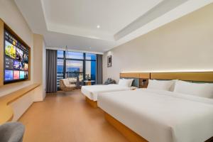 Postel nebo postele na pokoji v ubytování Tonglu City Center Rosery Hotel + 37 fotografií