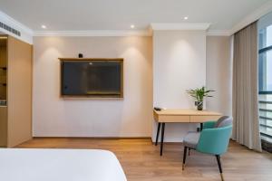 Postel nebo postele na pokoji v ubytování Tonglu City Center Rosery Hotel
