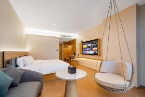 TV a/nebo společenská místnost v ubytování Tonglu City Center Rosery Hotel