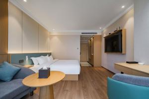 TV a/nebo společenská místnost v ubytování Tonglu City Center Rosery Hotel