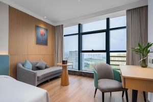 Postel nebo postele na pokoji v ubytování Tonglu City Center Rosery Hotel