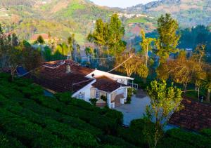 an aerial view of a house in the mountains at Silver Dale Tea Estate Bungalow Ooty by VOYE HOMES in Ooty