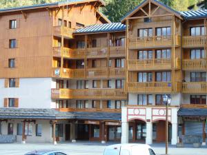 a large wooden building with balconies on it at Studio cosy 2/3 pers, proche remontées & commerces à Valfréjus - FR-1-561-88 in Valfréjus +3 photos