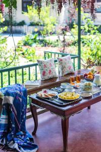 a table with a tray of food on it at SaffronStays Calamondinn Bungalow, Coorg in Gonikoppal