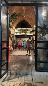 een groep mensen die in een kamer met een gebouw lopen bij The Temple Jaffa in Tel Aviv