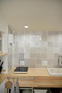 a kitchen with a counter with a sink and a counter sidx sidx sidx at Lalafofofo in Biei +64 photos