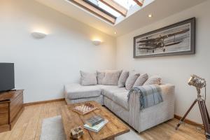 a living room with a couch and a coffee table at The Coach House - Beautiful Home in Cheltenham! in Cheltenham