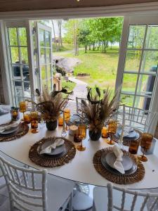 a table with plates of food on top of it at Sodyba Barracuda in Kupščiai