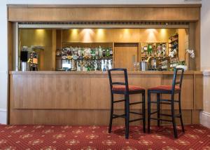 a bar with two stools at a counter at Haddon Hall Hotel in Eastbourne