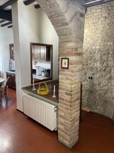 a brick wall with a counter in a kitchen at Casa dell Erbe in San Gimignano