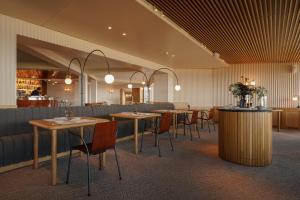 a restaurant with tables and chairs in a room at Akelarre - Relais & Châteaux in Donostia-San Sebastián