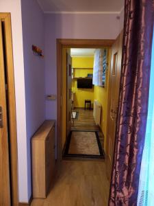 a hallway leading to a room with yellow walls at Apartament-Mieszkanie Gniezno-na doby in Gniezno +4 photos