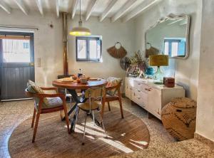 a dining room with a table and a mirror at Castillo Suite 15 Comares in Comares