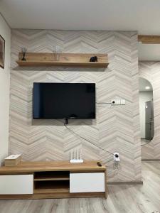 a living room with a television on a wall at Svečių namelis in Kaunas