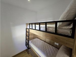 two wooden bunk beds in a room with white walls at Apartman C437 Aparthotel Vucko Jahorina privatni apartman in Jahorina +11 photos
