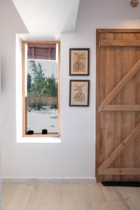 a room with a wooden door and a window at Agrambeli Apartments at Heraion Lagoon -By Bellavista Greece- in Loutraki
