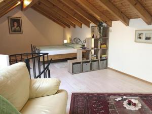 a living room with a couch and a bed at Casa Gialla by Fewotessin in Verscio
