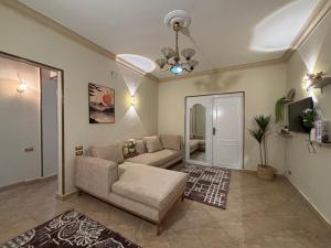 a living room with a couch and a table at Sunset homes in Downtown Cairo in Cairo