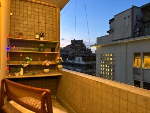 a chair on a balcony with a view of a city at Sunset homes in Downtown Cairo in Cairo