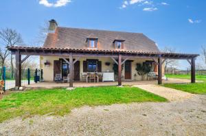 a house with a roof with a patio at Maison pour 6 avec piscine et grand jardin in Plazac