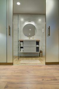 a bathroom with a sink and a mirror at Rozmaring Vendégház in Zalaegerszeg +20 photos