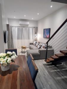 a living room with a couch and a table at Mopani Villa Victoria Falls in Victoria Falls