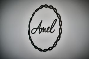 a black chain necklace with the word end on it at Hotel Amel Rooms in Mediaş