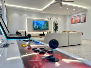 a living room with a game console and a couch at PortugueseSeaVilla 26pax in Melaka