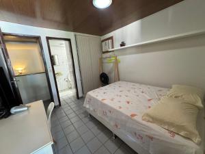 a small bedroom with a bed and a table at Casa Privê Maragogi Pé na areia in Maragogi +33 photos