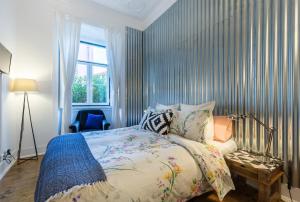 a bedroom with a bed and a chair and a window at House Sao Bento in Lisbon +105 photos