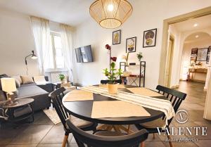a living room with a table and a couch at RomeCentralHouse,com - 50mt Metro Station - 20min walking from Colosseum - Elegant and fully equipped in Rome