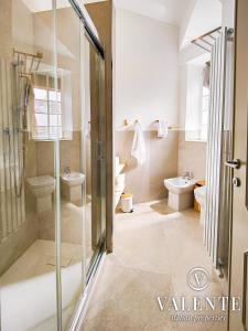a bathroom with a glass shower and a toilet at RomeCentralHouse,com - 50mt Metro Station - 20min walking from Colosseum - Elegant and fully equipped in Rome