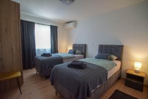 Ένα ή περισσότερα κρεβάτια σε δωμάτιο στο Apartman Petra