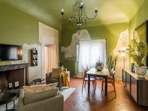 a living room with a fireplace and a chandelier at Canto degli Scali in Florence