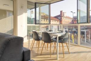 a dining room with a table and chairs at Suites in Financial District 4 pax in Milan