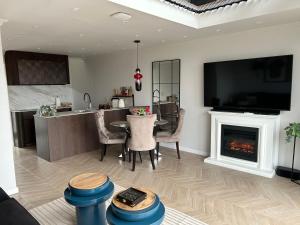 a living room with a table and a fireplace at Hill41 HORIZON KOTLINA KŁODZKA in Kłodzko