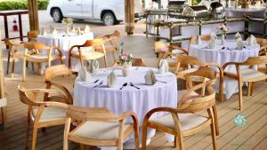 a group of tables and chairs with white tablecloths at Thailand Mountain Phuket in Patong Beach