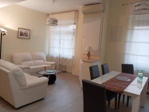 a living room with a couch and a table and chairs at Affittacamere Lusitana Alloggi 2 in Foligno