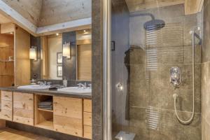 a bathroom with two sinks and a shower at Chalet Glisse in Megève +40 photos