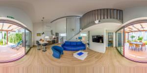 a living room with a blue couch and a table at Villa Klara in Vodice